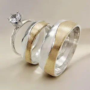 Argollas de matrimonio y anillo de compromiso con dos metales